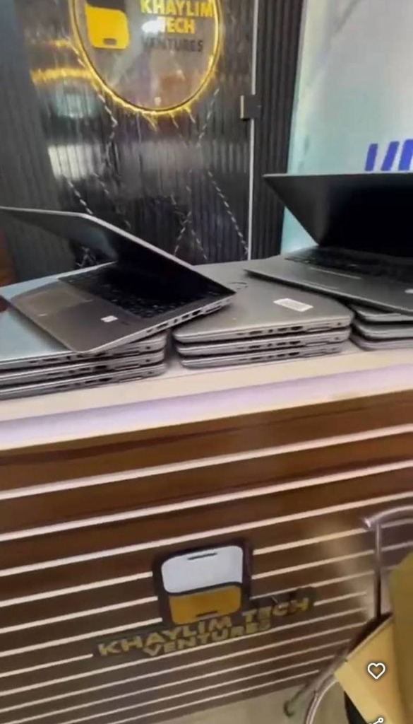 Stacks of genuine laptops on KhaylimTech showroom counter